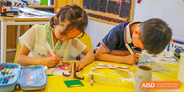 A BASIS International School Nanjing student concentrating on a book in a classroom.