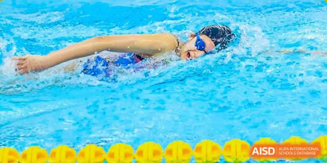 A BASIS International School Nanjing student swimming in a competition pool.