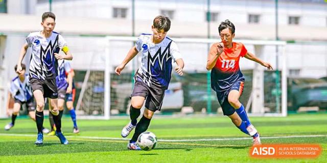 A BASIS International School Nanjing student playing soccer on a grass field.