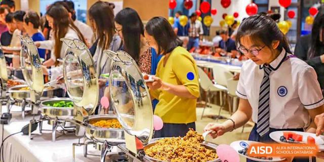 BASIS International School Nanjing students are serving themselves from a buffet line.