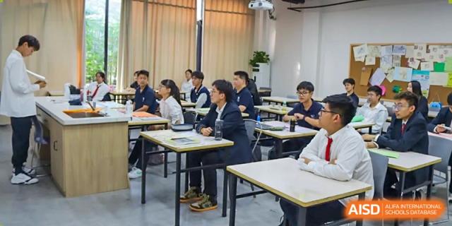 Vindu-Charlie Lakefield College students and adults seated at tables, participating in a formal meeting or business seminar.