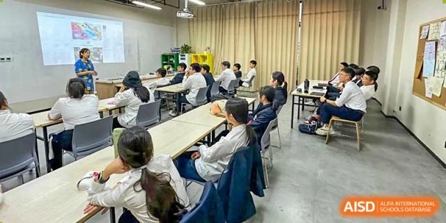 A classroom of Vindu-Charlie Lakefield College students seated at tables, listening to a lecture or presentation.