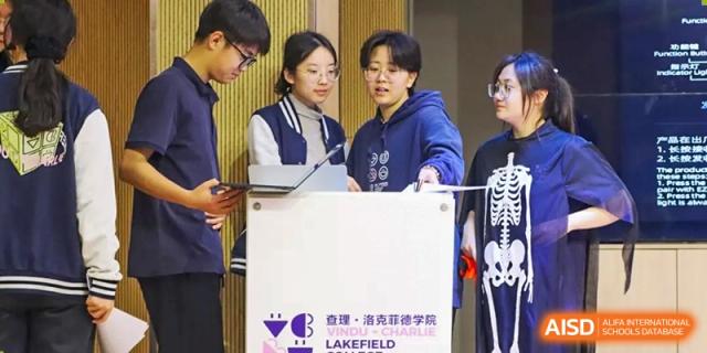 Two students stand at a podium, possibly giving a presentation or addressing an audience at Vindu-Charlie Lakefield College.