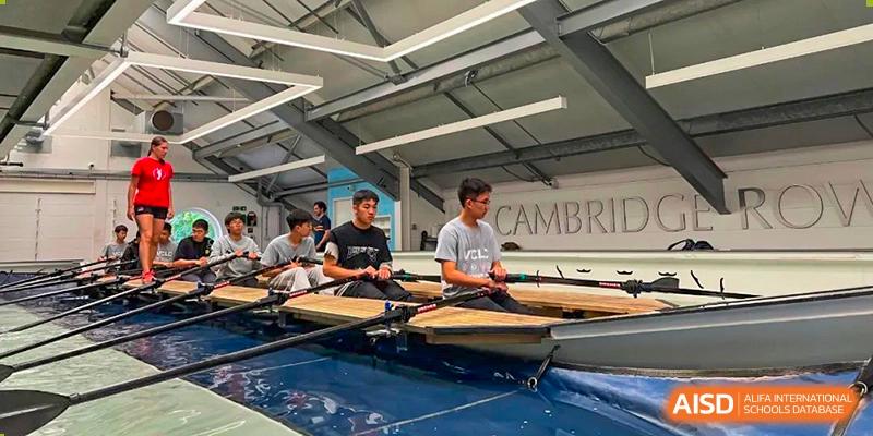 Vindu-Charlie Lakefield College students seated in a rowing shell on the water or indoors, preparing for a rowing practice or regatta.
