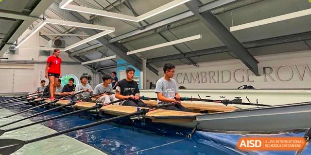 Vindu-Charlie Lakefield College students seated in a rowing shell on the water or indoors, preparing for a rowing practice or regatta.