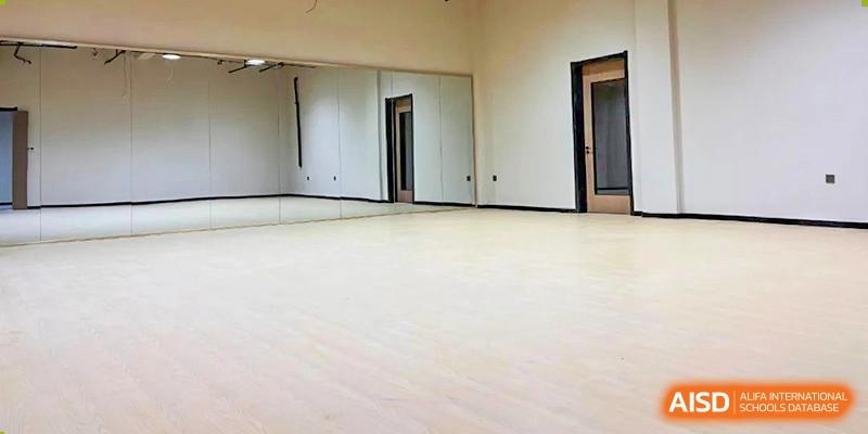 A bright, empty indoor space with light wooden floors, possibly a newly renovated classroom or common area at Vindu-Charlie Lakefield College.