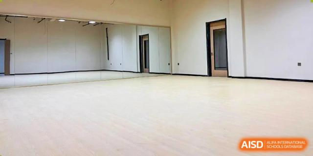 A bright, empty indoor space with light wooden floors, possibly a newly renovated classroom or common area at Vindu-Charlie Lakefield College.