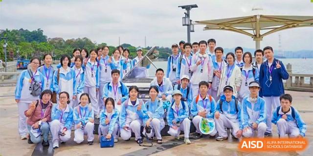 A large group of students from the CNUH-GA Curriculum Partnership Program posing for a group photo outdoors while wearing medals.