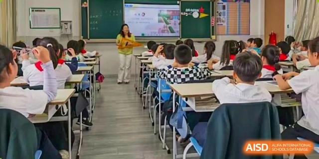 A view inside a bright Yancheng Foreign Language School classroom with students seated at their desks during a class.