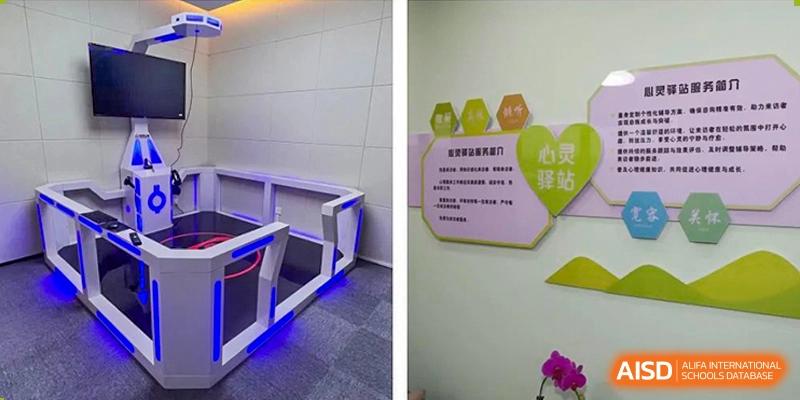 An interior photo showing a hallway with blue lighting near a barrier and a sign on a wall, likely within Yancheng Foreign Language School.