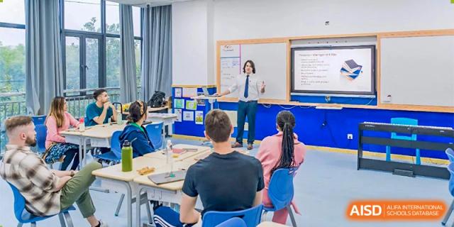 A teacher from Changwai Bilingual School giving a lesson to students in a classroom.