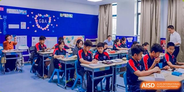 Students from Changwai Bilingual School seated at desks in a classroom, with a teacher at the front.