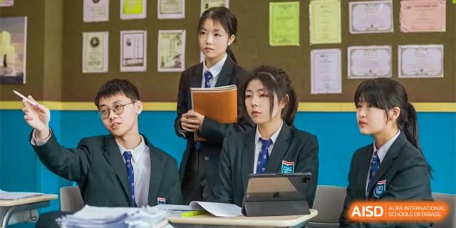 Two students from Changwai Bilingual School looking at a tablet together in a classroom.