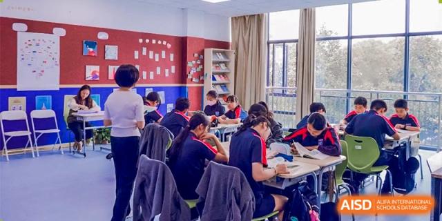 A wide shot of students from Changwai Bilingual School working in a classroom.