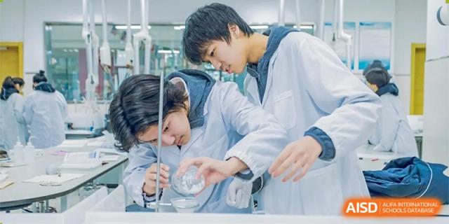 A student from Changwai Bilingual School conducting a science experiment in a lab.