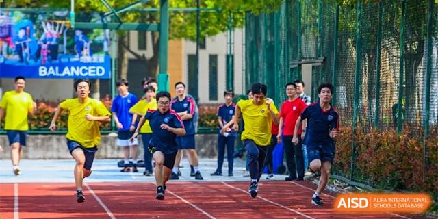 Changwai Bilingual School students running on sports field, race, athletics, speed, competition, outdoor exercise.