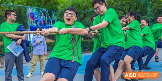 Changwai Bilingual School students participating in tug-of-war, team building, strength, fun, outdoor activity, competition.