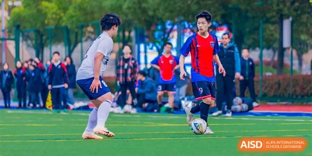 Changwai Bilingual School students playing soccer, team sport, outdoor, active, physical education, football.