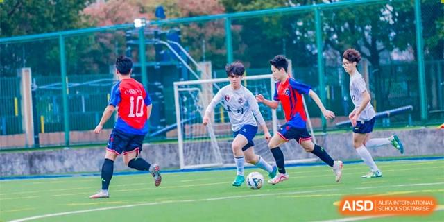 Changwai Bilingual School student dribbling soccer ball, game, football, active, sport, outdoor, individual skill.