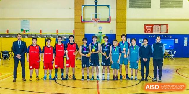 The basketball team from Changwai Bilingual School lined up on the court with their coaches.