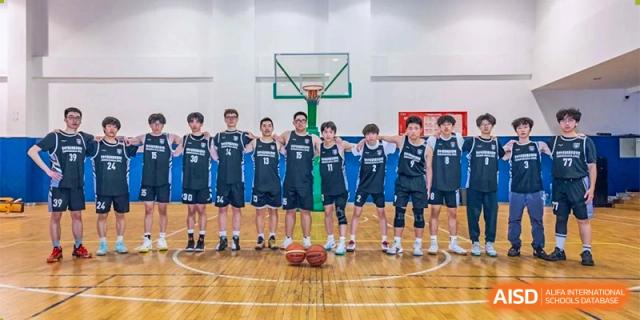 The boys' basketball team from Changwai Bilingual School posing with basketballs on the court.