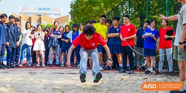 A student from Changwai Bilingual School jumping in the air during an outdoor sports activity.