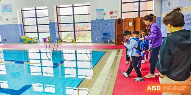 A view of the edge of the bright indoor swimming pool facility at Glocal Elite International School.