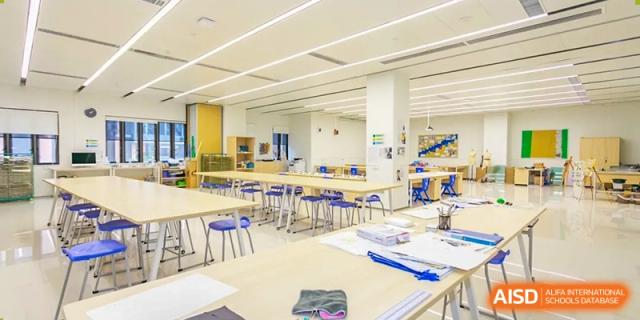 View of a bright, well-organized classroom or science lab with blue and yellow equipment at Harrow LiDe School Hengqin.