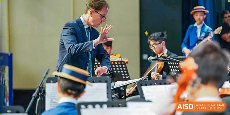 Close-up of students playing musical instruments as part of a band or orchestra at Harrow LiDe School Hengqin.