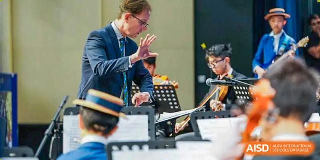 Close-up of students playing musical instruments as part of a band or orchestra at Harrow LiDe School Hengqin.