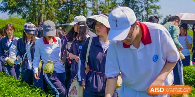 A group of students walking together, some wearing hats, at the High School Affiliated to Shanghai Jiao Tong University.