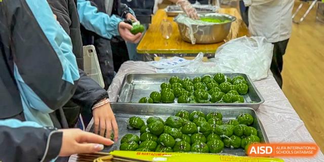 A close-up of a tray filled with many bright green, round food items at the High School Affiliated to Shanghai Jiao Tong University.