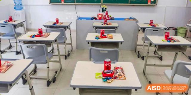A close-up of a student desk set up with materials for an activity or class at the Guangdong Overseas Chinese High School International Curriculum.