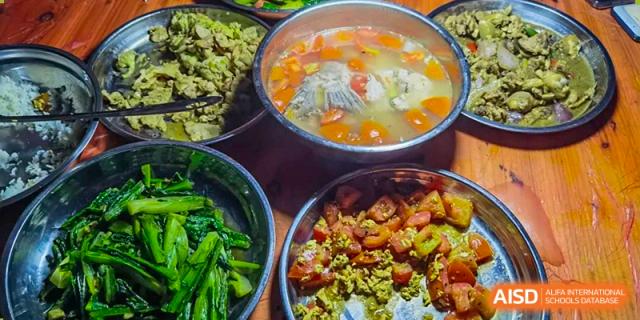 A selection of healthy and nutritious dishes, including green vegetables and a soup, served at the Guangdong Overseas Chinese High School International Curriculum cafeteria.