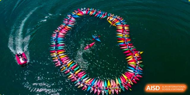 An aerial view of a large, colorful spiral made of colored pencils at Wahaha Bilingual School Hangzhou.