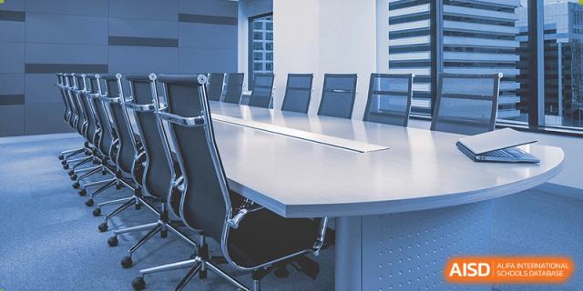 A large, clean meeting room with a conference table and chairs at Wahaha Bilingual School Hangzhou.
