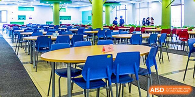 A modern and colorful cafeteria seating area with blue and yellow chairs at Wahaha Bilingual School Hangzhou.