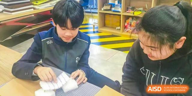 Students from Shanghai United International School Hefei Campus collaborating on a school project.