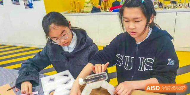 Students from Shanghai United International School Hefei Campus building a device as part of a class.
