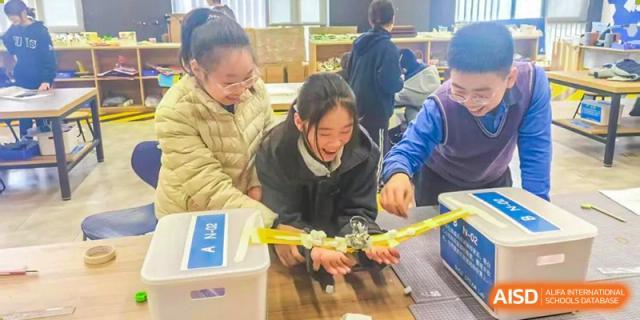 A teacher helping a student from Shanghai United International School Hefei Campus with a project.