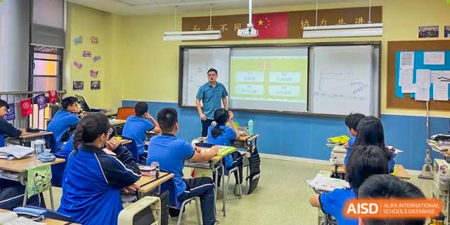 A teacher from Shanghai United International School Hefei Campus teaching in a classroom setting.