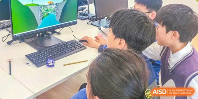 A student from Shanghai United International School Hefei Campus using a computer for a school project.