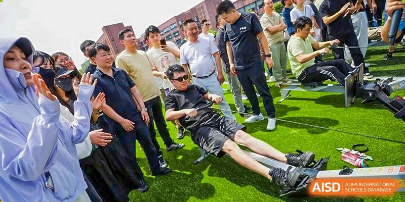 A student from Shanghai United International School Hefei Campus doing an acrobatic move on a sports field.
