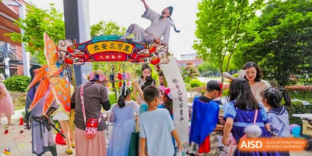 A group of students from Shanghai United International School Hefei Campus watching a traditional performance.