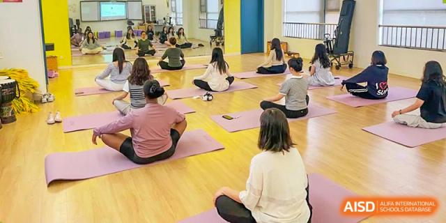 Students and teachers from Shanghai United International School Hefei Campus participating in a yoga class.