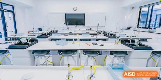 A clean and modern science laboratory at Adcote School Shanghai, with multiple workstations and safety equipment.