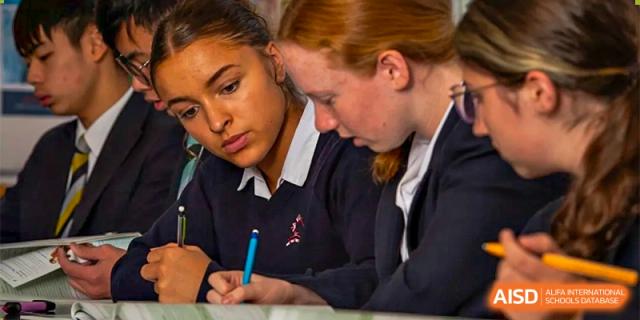 Two female students, one with red hair, working on an assignment together at Bromsgrove School Mission Hills.