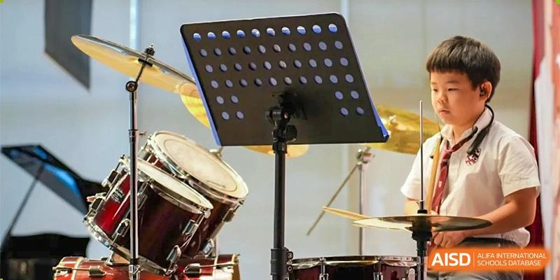 A drum set and other musical instruments on a stage, ready for a performance at Bromsgrove School Mission Hills.
