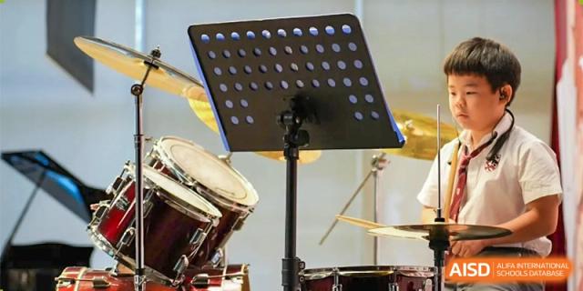 A drum set and other musical instruments on a stage, ready for a performance at Bromsgrove School Mission Hills.