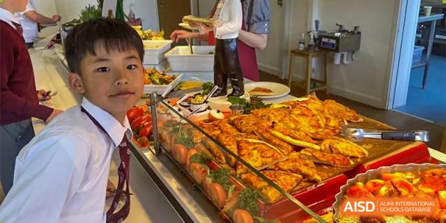 A variety of dishes and food displayed in a buffet line in the canteen at Bromsgrove School Mission Hills.